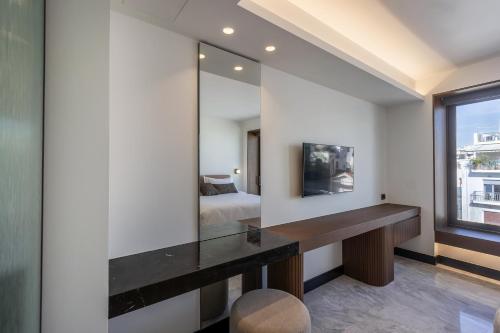 a bedroom with a bed and a mirror at L'Avventura Suites in Athens
