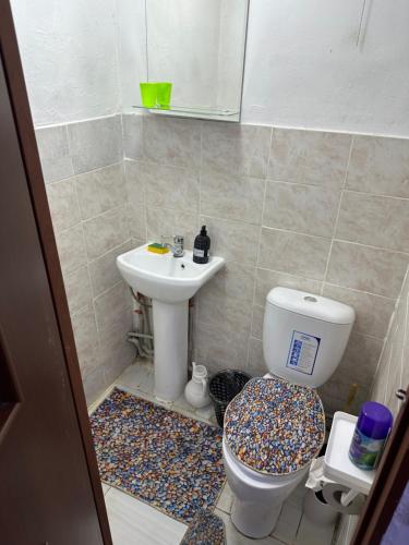 a bathroom with a toilet and a sink at Хостел на Каримова in Almaty
