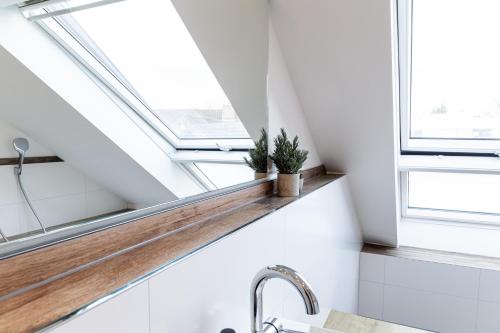a bathroom with skylights and a sink and a window shelf at living TIMELESS - Apartments zum roten Lamm- Bad Krozingen in Bad Krozingen