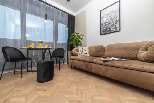 a living room with a couch and a table at Premium Apartamenty Grunwaldzka 25A in Bydgoszcz