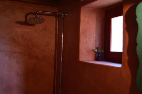 a shower in a room with a window at Anemi in Káto Pediná