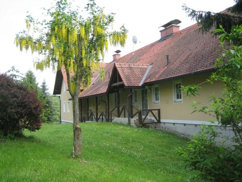 a house with a tree in the yard at Landhaus Piber in Piber