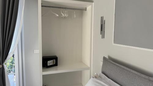 a bedroom with a bed and a mirror and a clock at AC GOLD B&B Boutique Rooms & Suite in Reggio Calabria