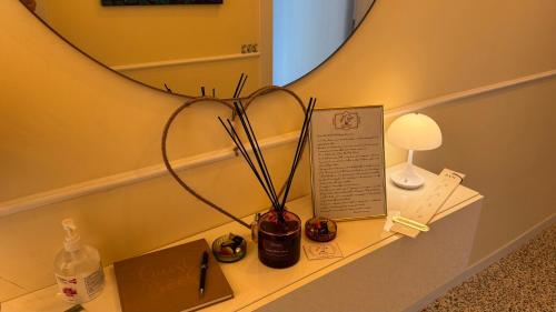 a table with a vase on a shelf with a mirror at AC GOLD B&B Boutique Rooms & Suite in Reggio Calabria
