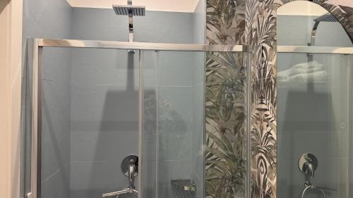 a bathroom with a shower with a glass door at AC GOLD B&B Boutique Rooms & Suite in Reggio Calabria