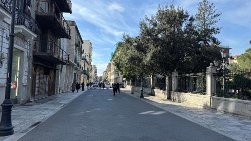an empty street with people walking down the street at AC GOLD B&B Boutique Rooms & Suite in Reggio Calabria