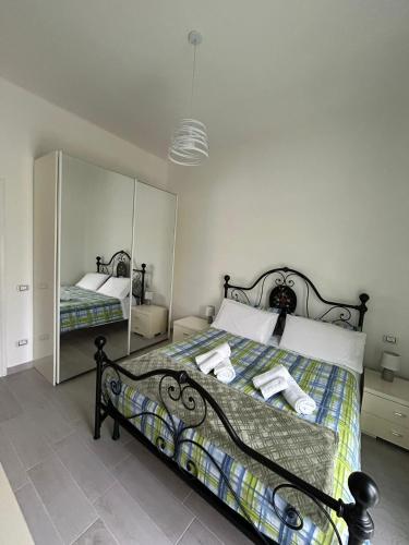 a bedroom with a bed and a mirror at G&D House in Latina