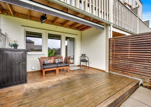 a porch with a bench on a wooden deck at Apartment near Oslo, Drammen, and a lake in Lier