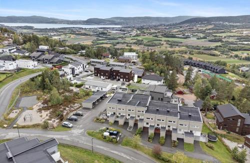 an aerial view of a town with houses and a street at Apartment near Oslo, Drammen, and a lake in Lier