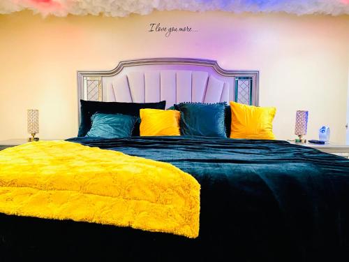 a bedroom with a large bed with a yellow blanket at Sweet Home Georgia Enchanté in Norcross
