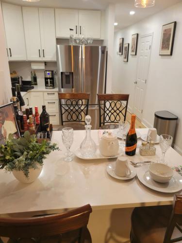 a kitchen with a table with plates and wine glasses at Brooklyn Luxury Suite in Brooklyn