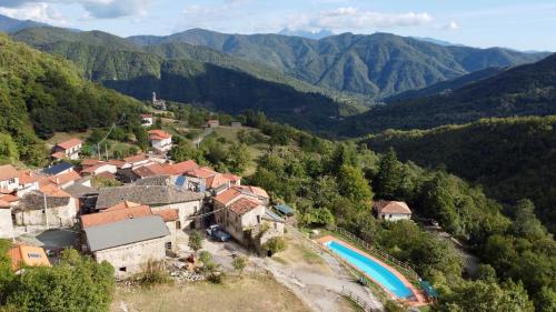 an aerial view of a village in the mountains at Agriturismo Montagna Verde Apella in Licciana Nardi
