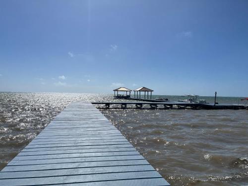 a dock in the water with a building on it at Captain Morgan's Retreat in San Pedro