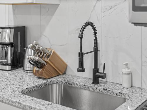 a kitchen counter top with a sink and a kitchen practition at Lawrenceville Central !2 Stylish and Quiet One Bedroom Apartment with Free Street Parking in Pittsburgh
