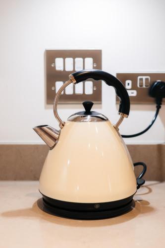 a tea kettle sitting on a kitchen counter at Peaceful Apartment in East End in London