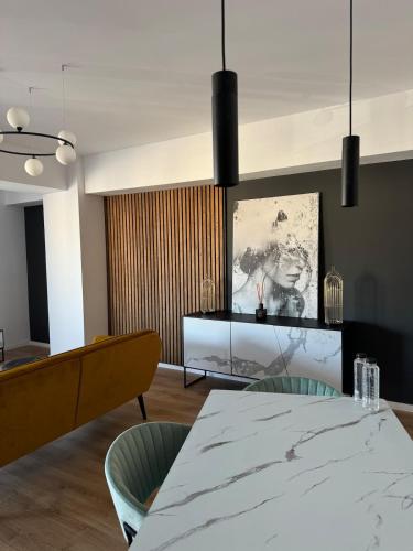 a dining room with a table and two chairs at CityCenter Heart - Ultracentral & Panoramic View in Reşiţa