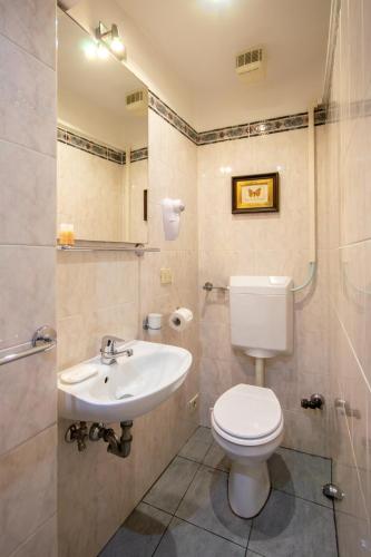 a bathroom with a toilet and a sink at Althea Rooms in Florence