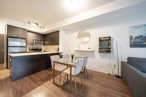 a kitchen and living room with a table and a couch at Spectacular Suite in the Heart of Toronto in Toronto