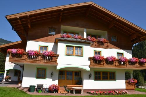 a house with flowers on the balconies at Holiday-Appartements in Flachau