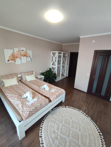 a bedroom with a large bed and a rug at Карпатська Вершина in Yaremche
