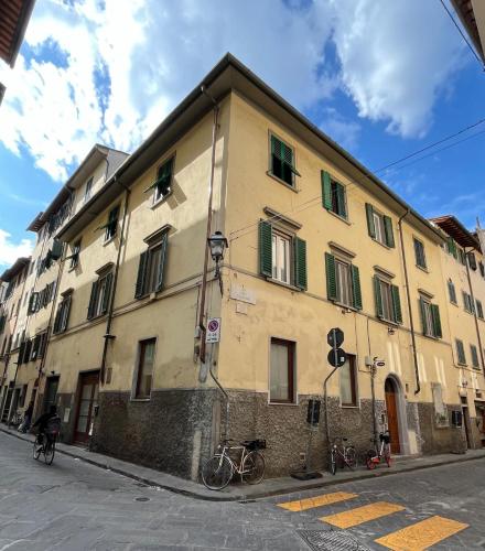 a building with bikes parked in front of it on a street at Althea Rooms in Florence