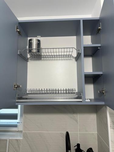 a shelf in a kitchen with a counter top at Toscana Apartments in Otopeni