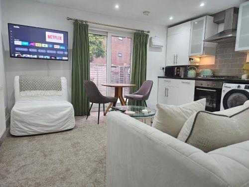 a living room with a couch and chairs and a table at StayZen Apartments - Private Garden & Free Parking Ground Floor Central Woking - Business & Leisure in Woking