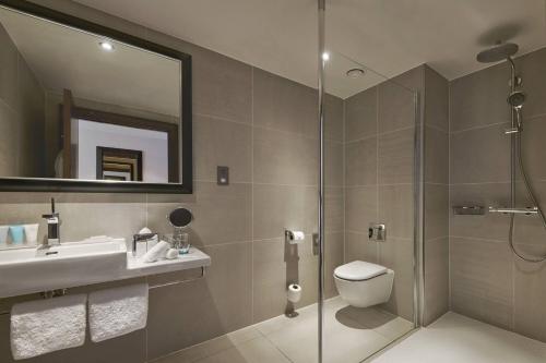 a bathroom with a shower and a sink and a toilet at The Glasshouse, Autograph Collection in Edinburgh
