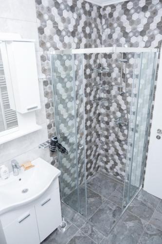 a shower with a glass door in a bathroom at Apartment Friday in Travnik