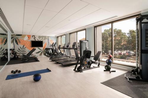 a gym with treadmills and exercise equipment in a building at Courtyard by Marriott Perth Murdoch in Fremantle