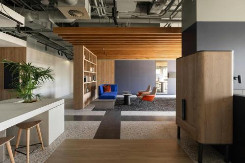 an office lobby with blue and orange chairs at Courtyard by Marriott Perth Murdoch in Fremantle