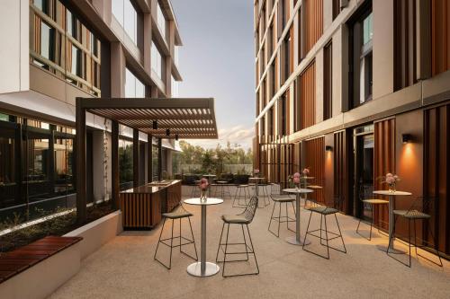 a balcony with tables and chairs on a building at Courtyard by Marriott Perth Murdoch in Fremantle