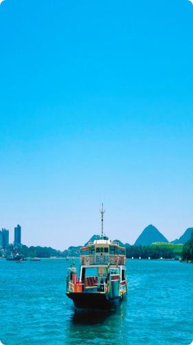 a boat floating on a large body of water at Yeosu UTOP UBLESS All Rooms Stunning Ocean View in Yeosu