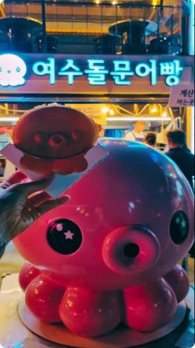 a toy pig sitting on top of a plate at Yeosu UTOP UBLESS All Rooms Stunning Ocean View in Yeosu