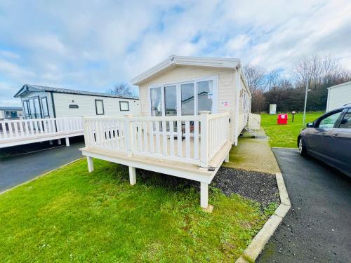 a tiny house is parked in a parking lot at 3 Bedroom Caravan OG35, Lower Hyde, Shanklin in Shanklin