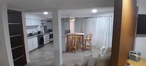 a kitchen with a table and chairs in a room at Alma de Mar in Necochea