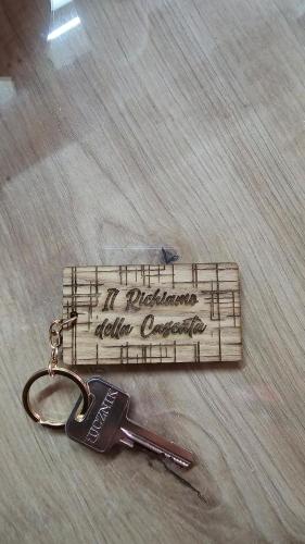 a pair of keys sitting on top of a wooden instrument at Il Richiamo della Cascata in Papigno