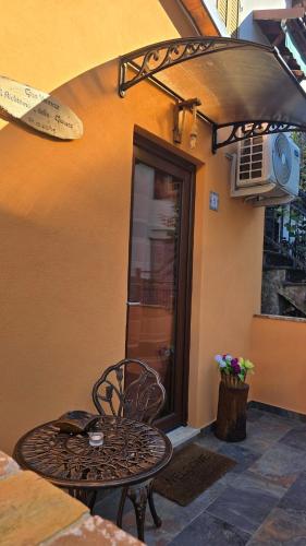 a table and chair in front of a building at Il Richiamo della Cascata in Papigno