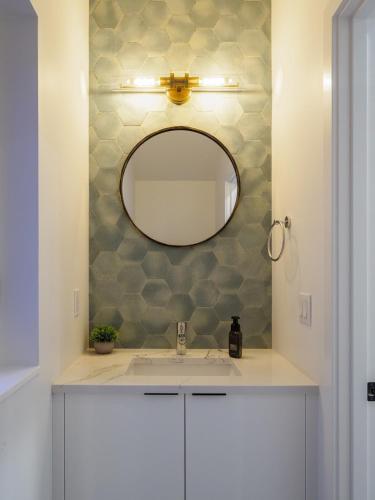 a bathroom with a sink and a mirror at Steps to Alki Beach with Water Views Rooftop deck in Seattle