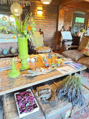 a living room with a wooden table with a green vase at Le Bouquet Apart Hotel in San Carlos de Bariloche