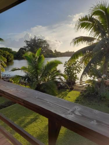 a view of a river from a bench at Te Mana Lodge iti in Taravao