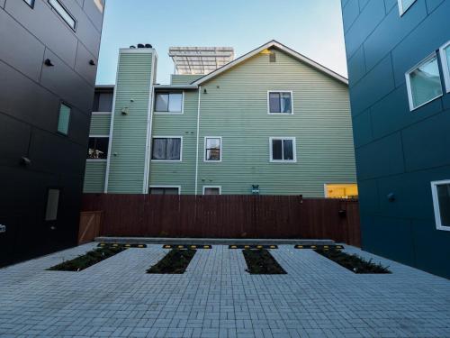 a courtyard with some plants in front of a building at Steps to Alki Beach with Water Views Rooftop deck in Seattle
