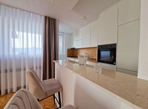 a kitchen with a counter top in a room at Avdina Luxury Apartment in Sarajevo