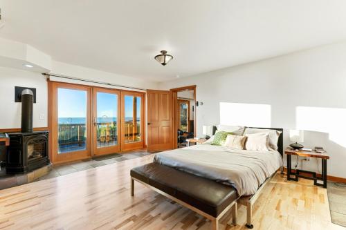 a bedroom with a large bed and a fireplace at Pacific Bliss in Elk