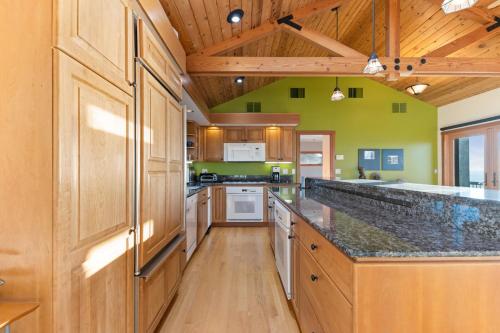 a large kitchen with wooden cabinets and a counter top at Pacific Bliss in Elk