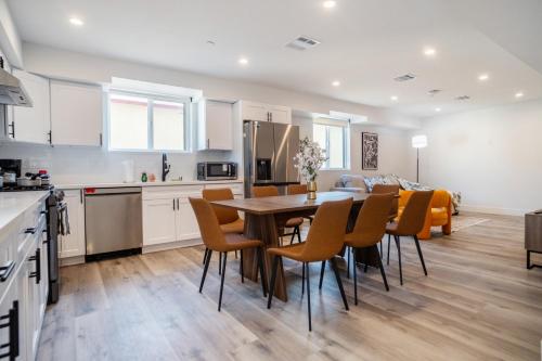 a kitchen and dining room with a table and chairs at Cozy LA Retreat Near USC Steps to Koreatown & Downtown in Los Angeles