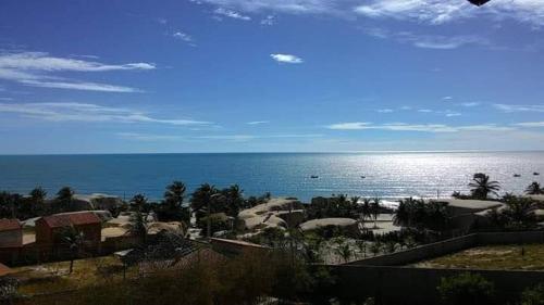 a view of the beach with the ocean in the background at Chalés Luz do Luar in Aracati