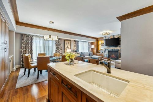 a kitchen and living room with a sink and a living room at St. Regis Deer Valley in Park City