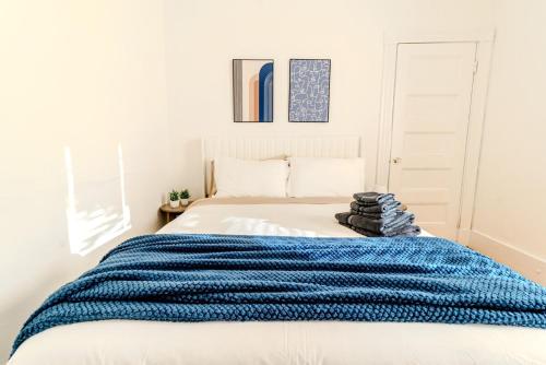 a bedroom with a bed with a blue blanket on it at Harvard 3BDR- 5 Min Walk to Davis Sq - Free Parking in Somerville