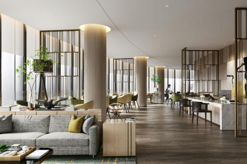 a living room with a couch and a bar at Courtyard by Marriott Hangzhou Xihu in Hangzhou
